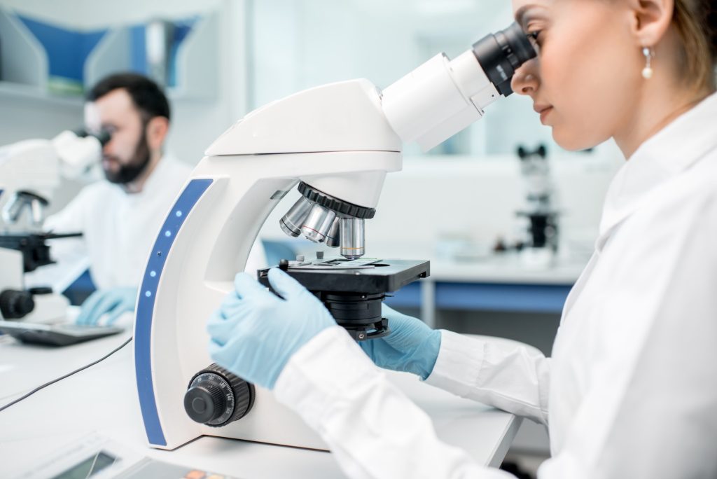 Medics working with microscope at the laboratory